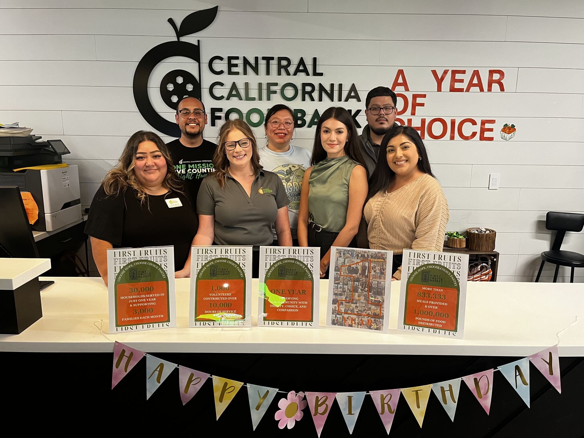 Nutrition and health center volunteers serving community members representing the intersection of wellness nutrition and healthy living programs